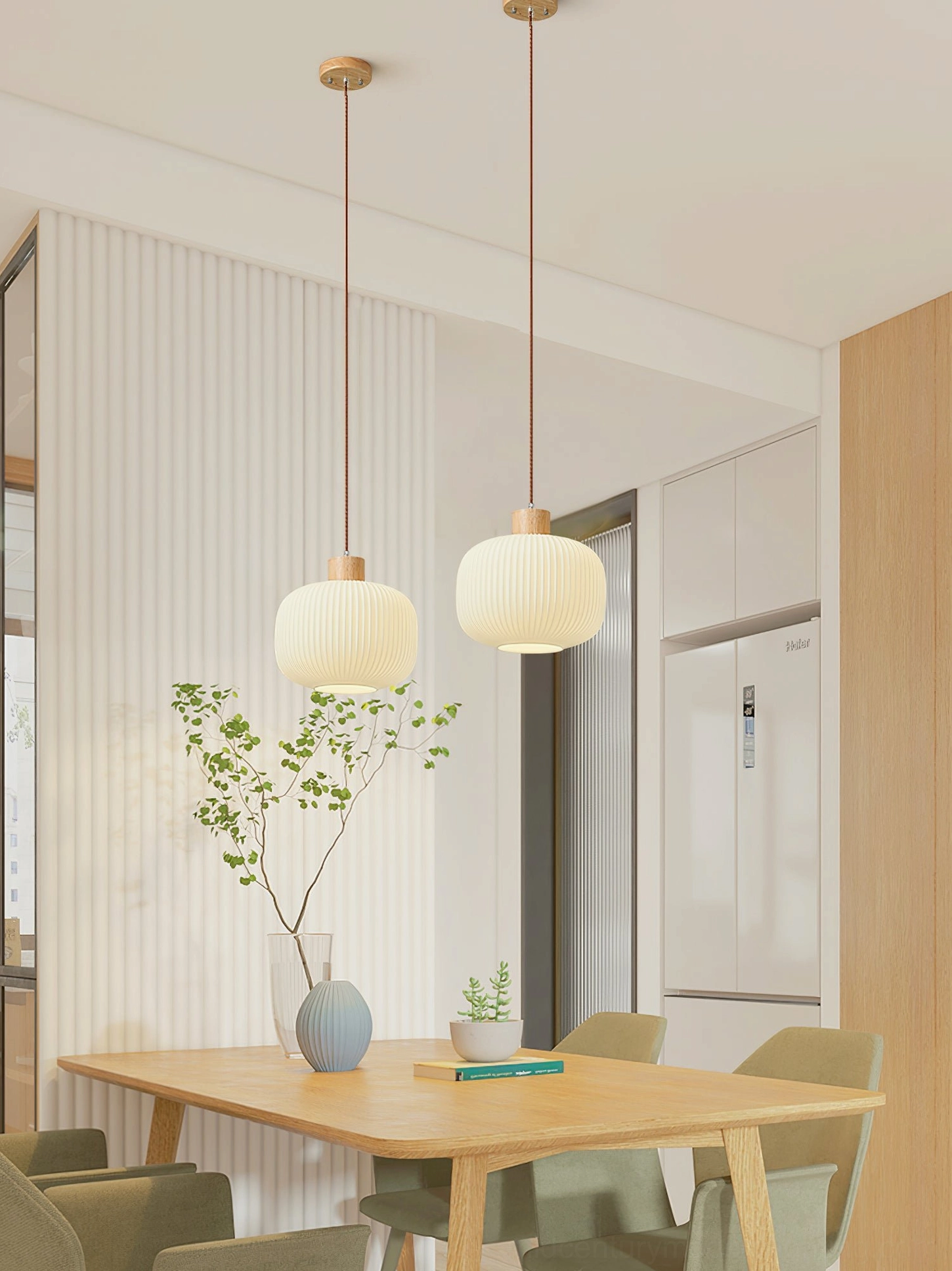 Two Rime pendant lamps clustered over small casual dining area with minimalist Japandi styling
