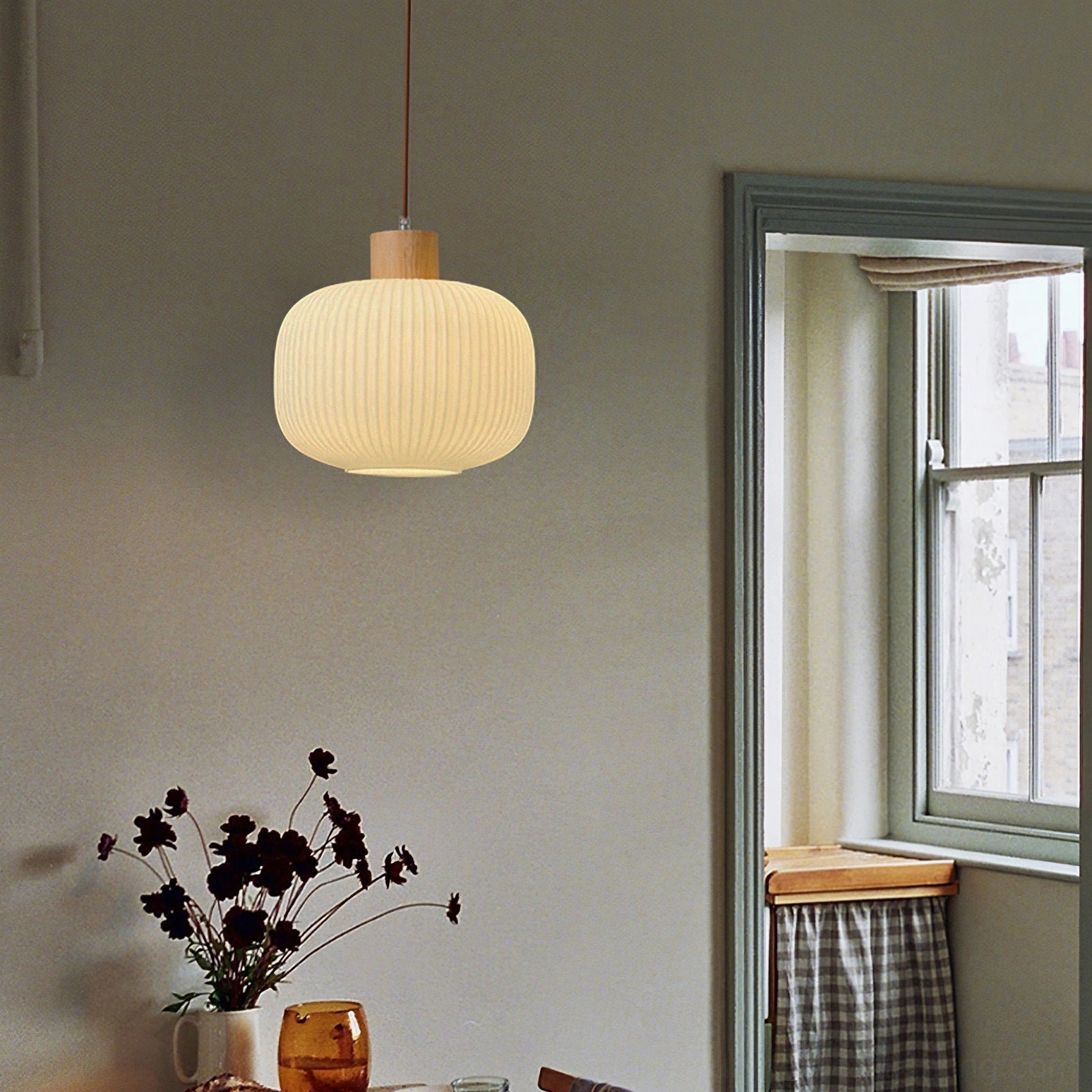 Multiple Rime pendant lamps in linear arrangement over kitchen island at equal heights