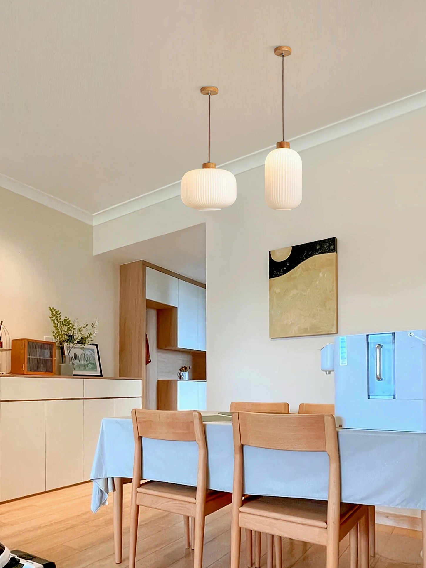 Single Rime pendant lamp suspended from ceiling in minimalist mid-century modern interior