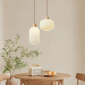 Pair of Rime pendant lamps in warm Japandi dining room setting with wooden table and neutral decor