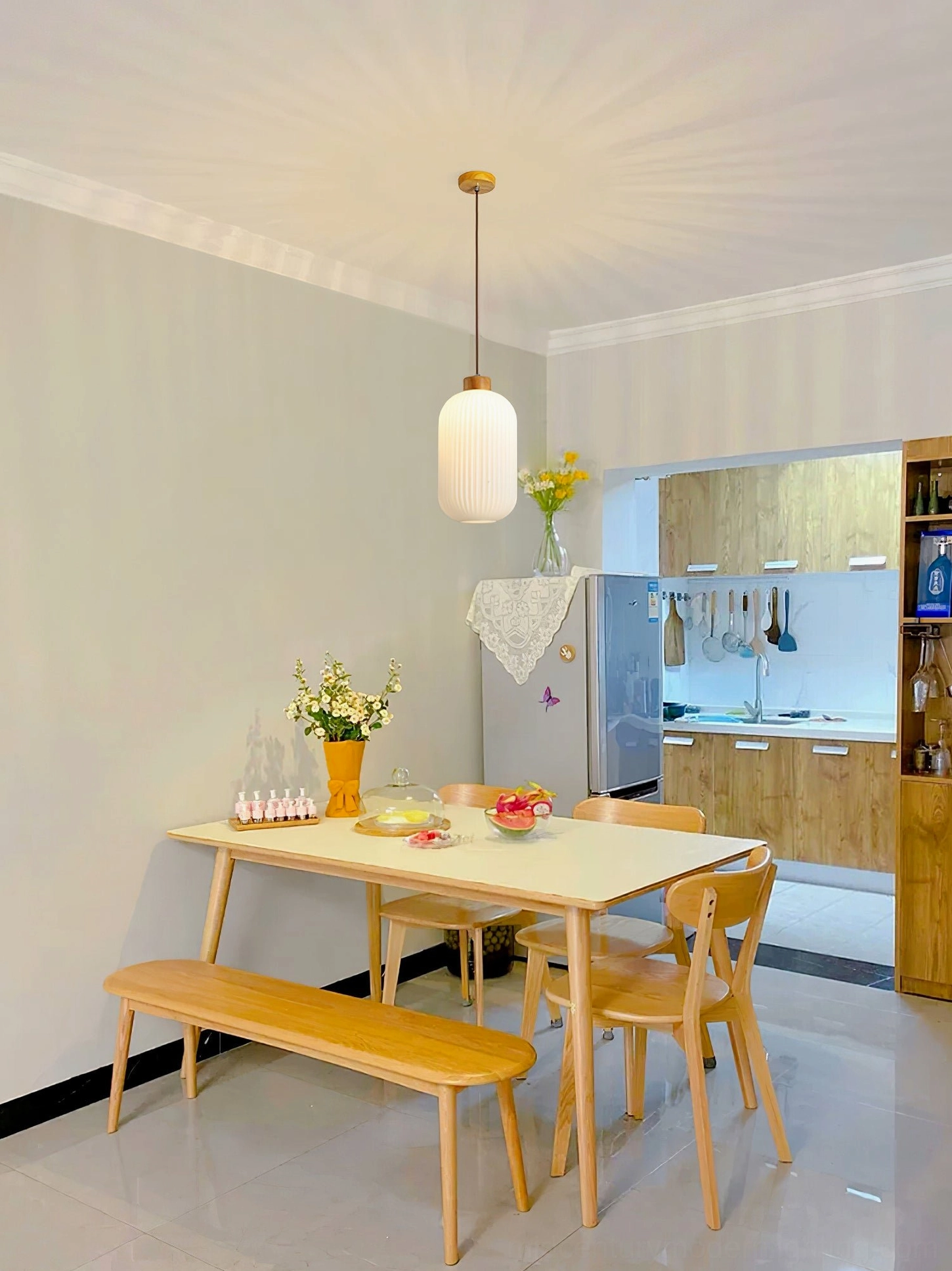 Single Rime pendant lamp above wooden dining booth in warm Scandinavian interior