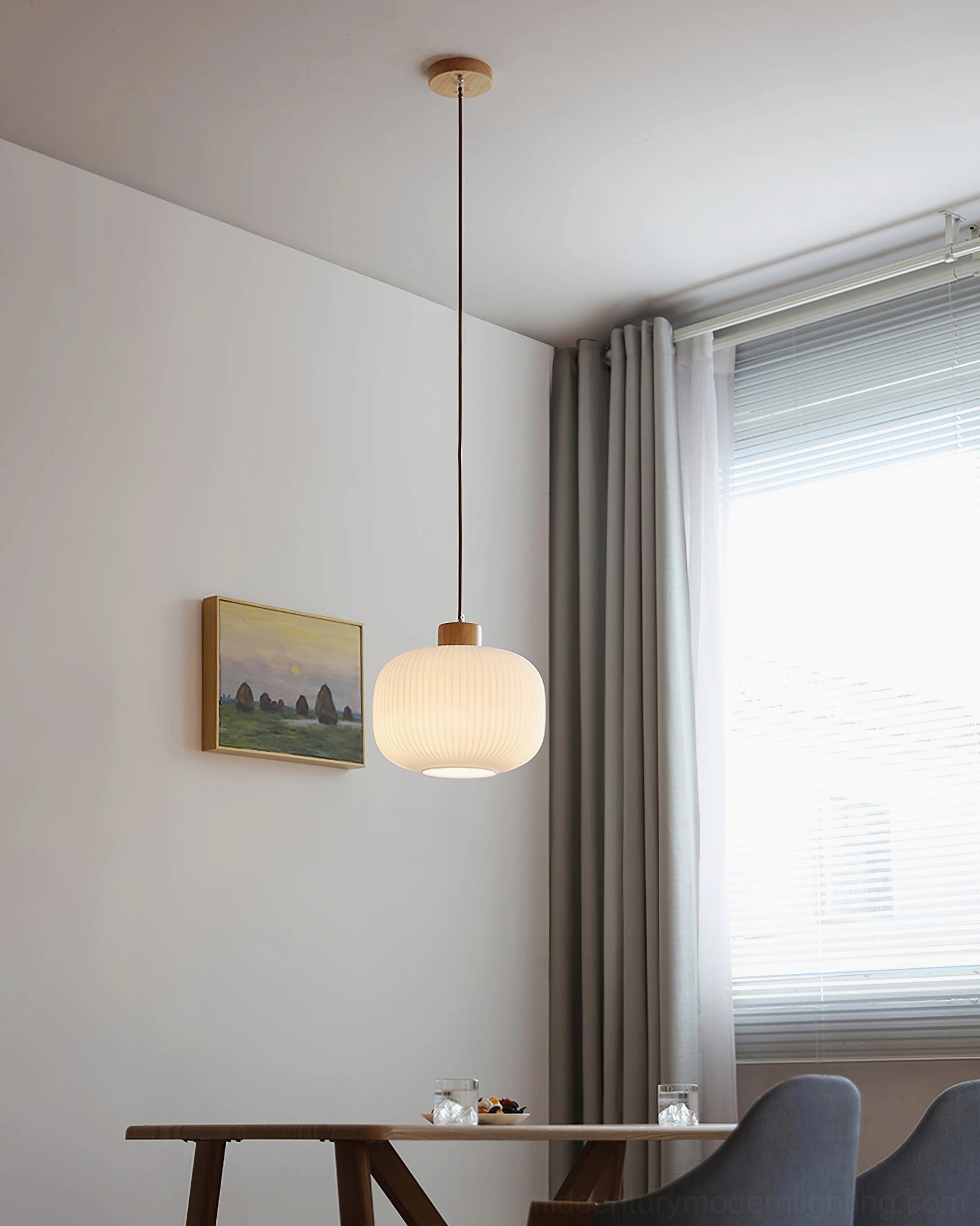 Two Rime pendant lamps in staggered heights creating layered visual rhythm in dining space