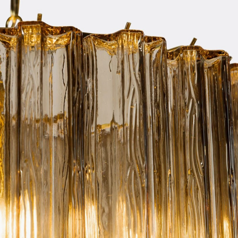 Close-up macro detail of Rina Firenze ribbed amber glass prisms showing Murano craftsmanship texture