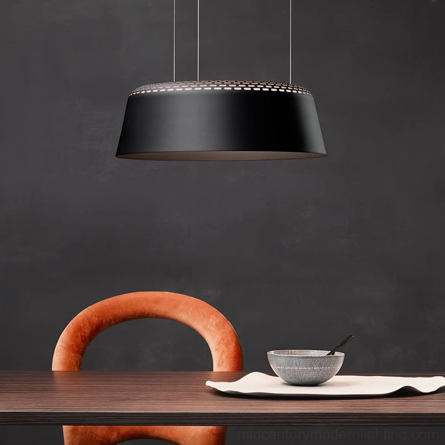 Ring black pendant lamp close-up view over minimalist dining table with dark accent wall