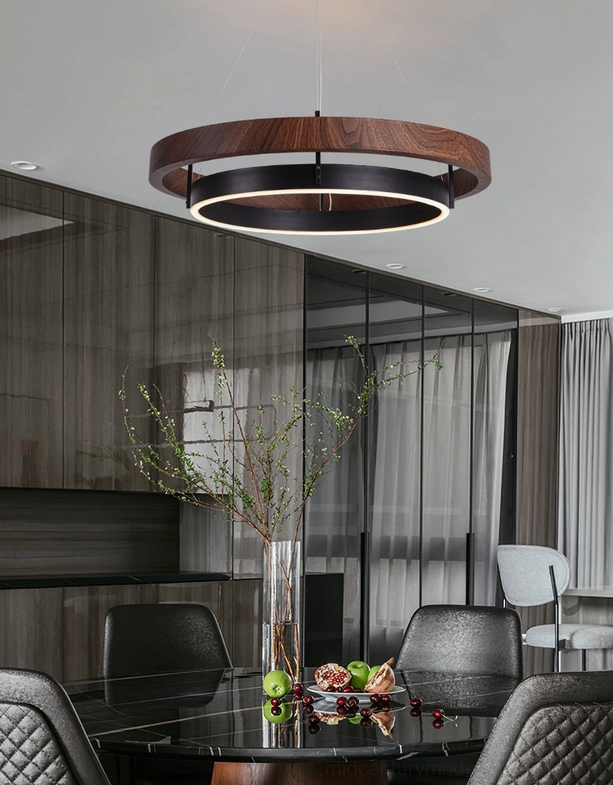 Double-ring pendant light suspended above modern glass dining table in sophisticated minimalist interior
