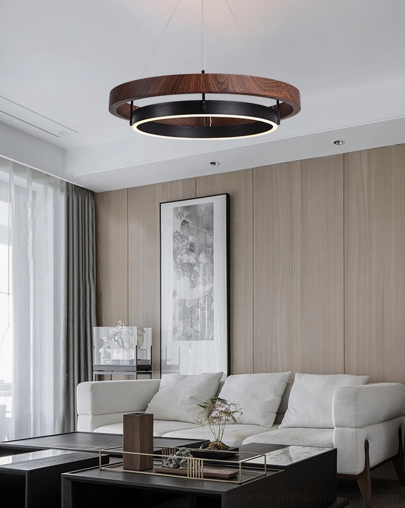 Double-ring pendant chandelier glowing above neutral living room seating area modern minimal design