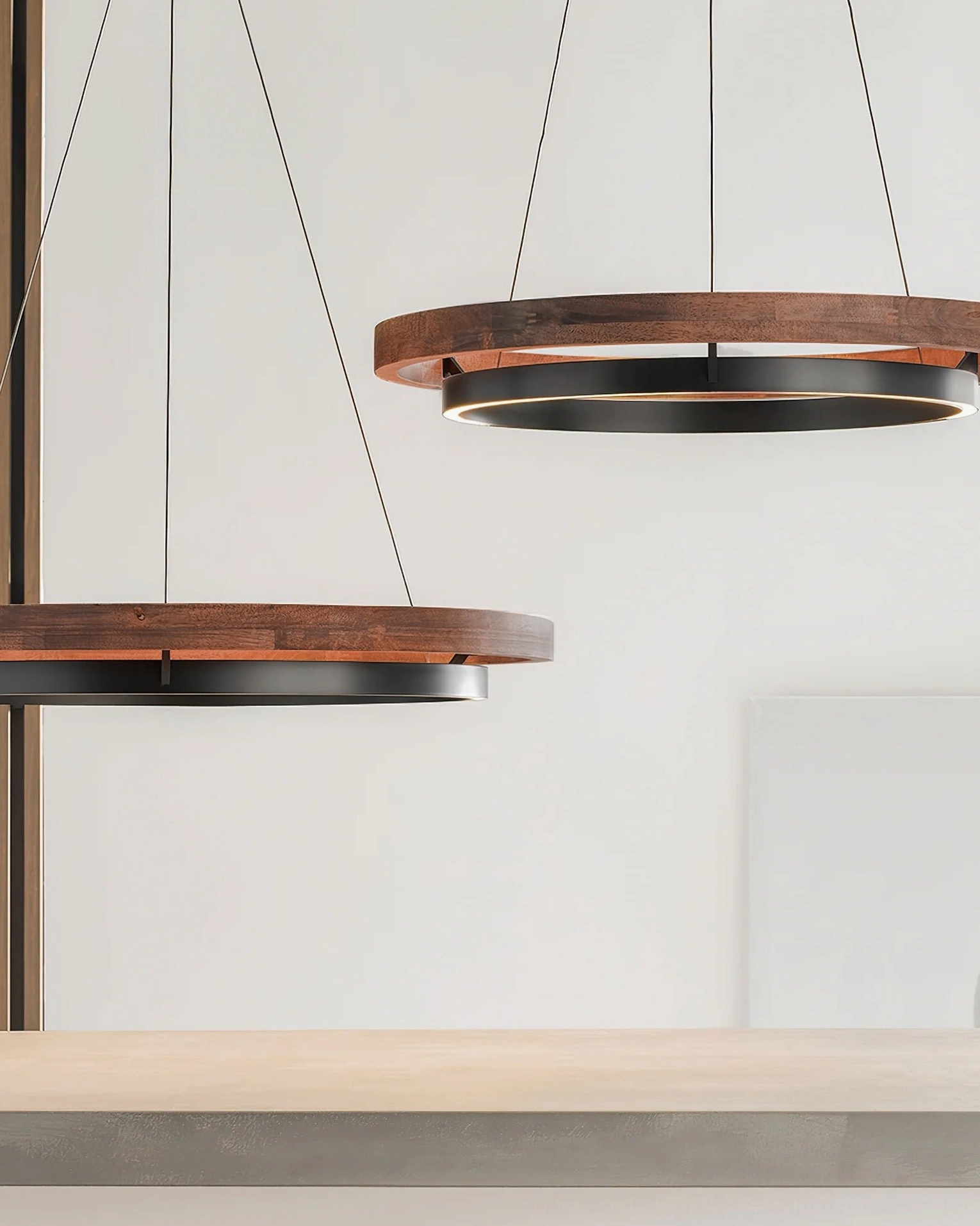 Pair of Ring Dunst double-ring pendants in walnut and matte black finish over console table