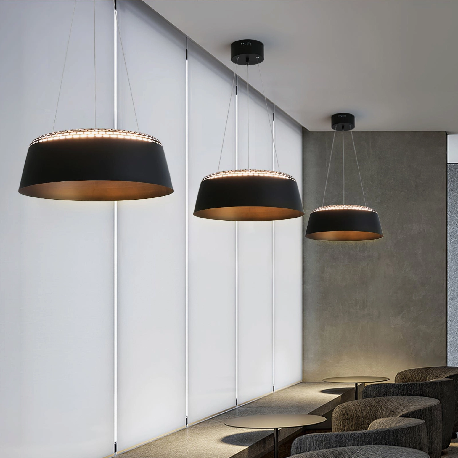Ring black drum pendant with gold inner trim over modern dining lounge, perforated top edge detail