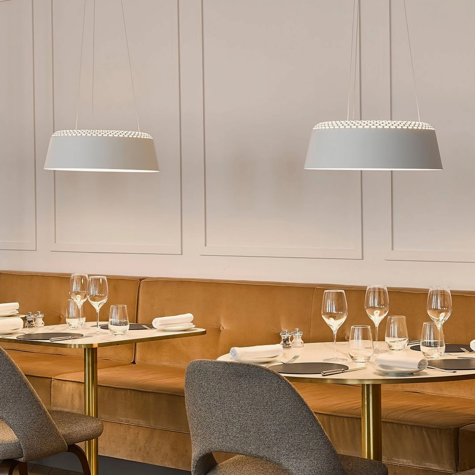 Ring white drum pendant in upscale restaurant booth with matching fixtures and golden hardware, fine dining scene