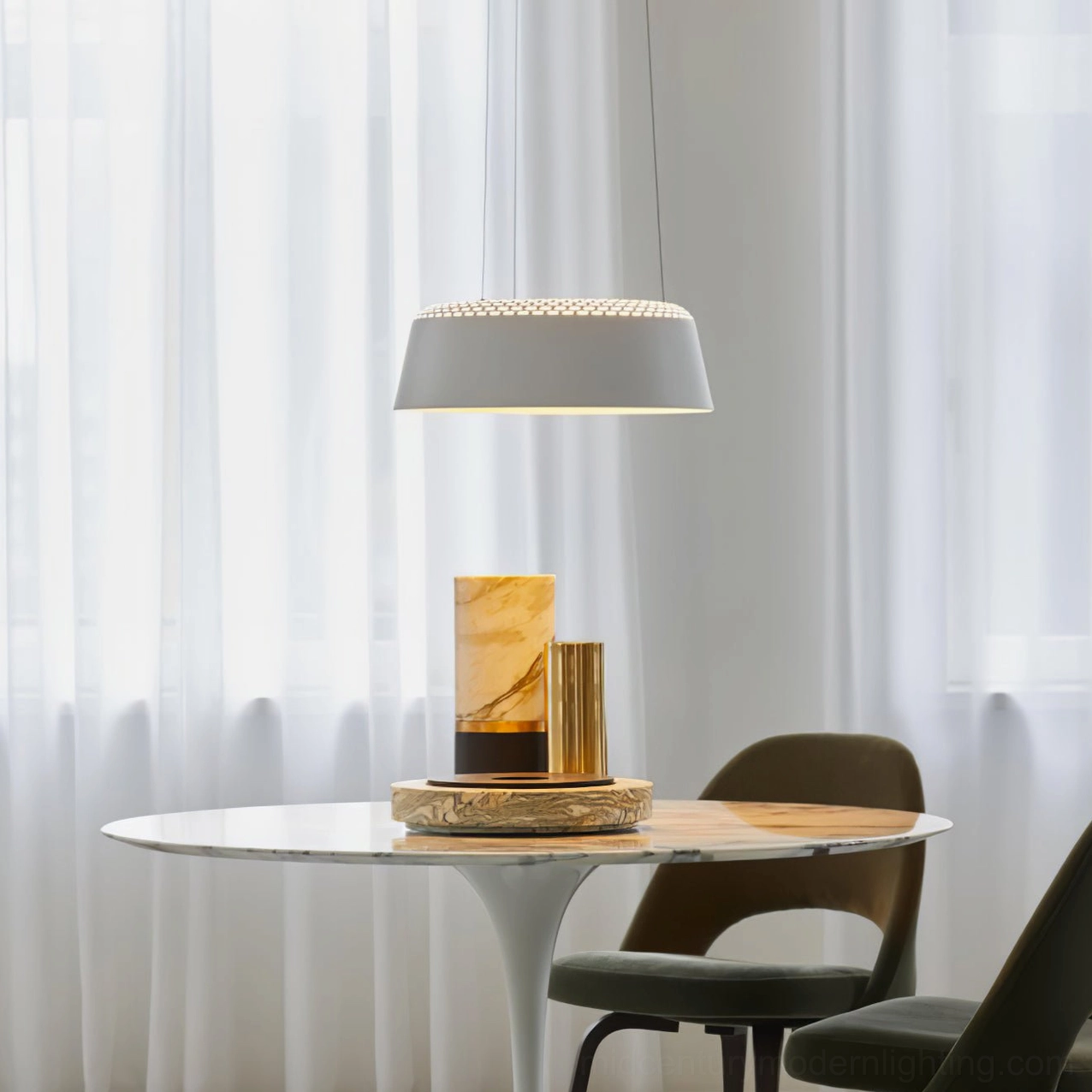 Ring white pendant lamp side view above dining nook with warm ambient illumination and sheer curtain backdrop