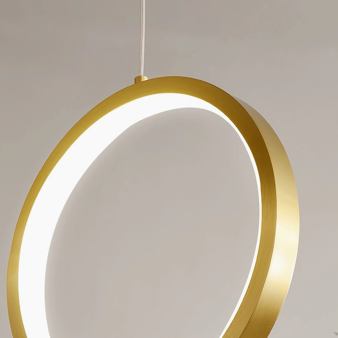 Rings single brass ring pendant lamp close-up warm LED light glowing mid-century modern design