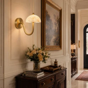 Ripple wall sconce installed in entryway with warm ambient light creating soft glow through alabaster