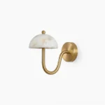 Ripple alabaster wall sconce with curved brass arm and natural stone dome shade, front view