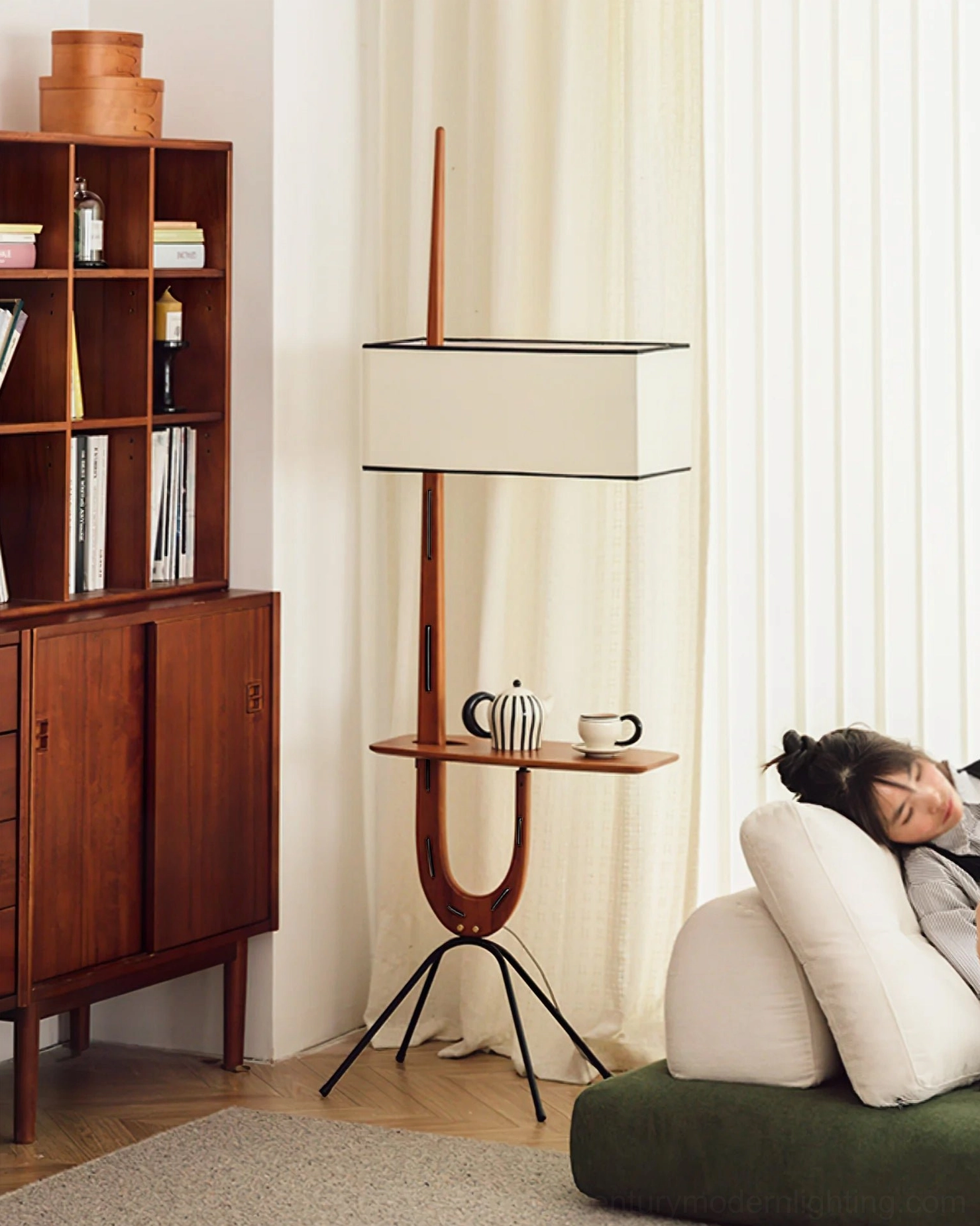 Rispal Floor Lamp integrated console shelf at chair-arm height with book and reading accessories, functional shelf styling detail