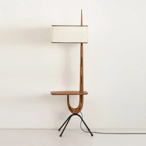 Mid-century modern floor lamp showing cable routing alongside walnut column with visible gap, studio photography with white backdrop