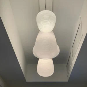 Multiple Rituals pendant lights stacked varying sizes suspended ceiling residential interior warm lighting