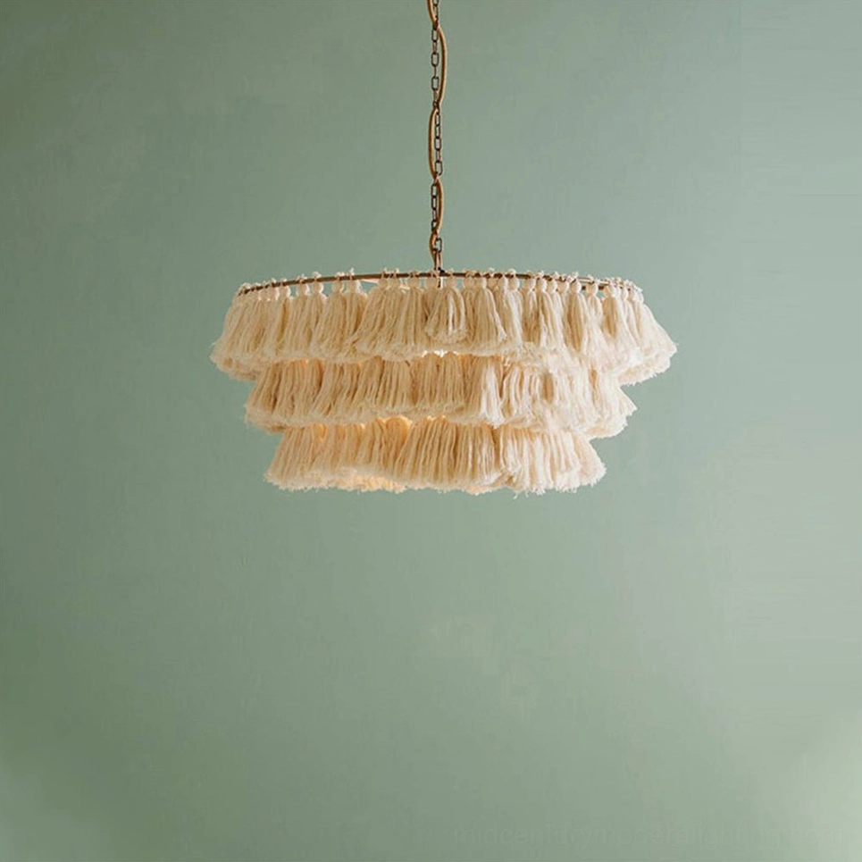 Pink bohemian tassel pendant light adding soft romantic accent to curated interior space