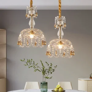 Dual Rondelle crystal pendant lights installed over dining table, warm brass fixtures, neoclassical luxury interior design