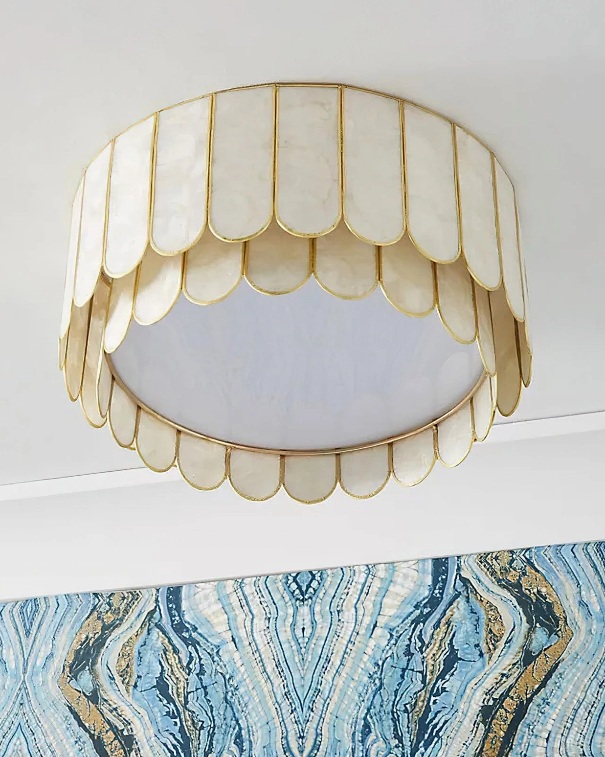 Rosa Capiz flush mount ceiling lamp installed in residential interior with blue marbled accent wall, warm ambient lighting