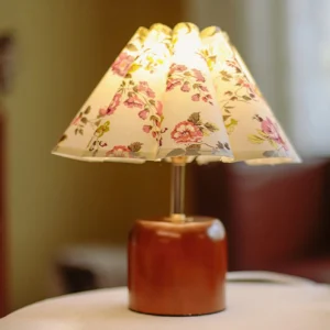 Vintage floral table lamp in home interior setting with three-quarter view, warm ambient lighting on tabletop