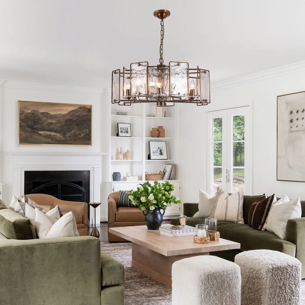 Rosalind mid-century modern chandelier installed in traditional living room with fireplace and green sofa