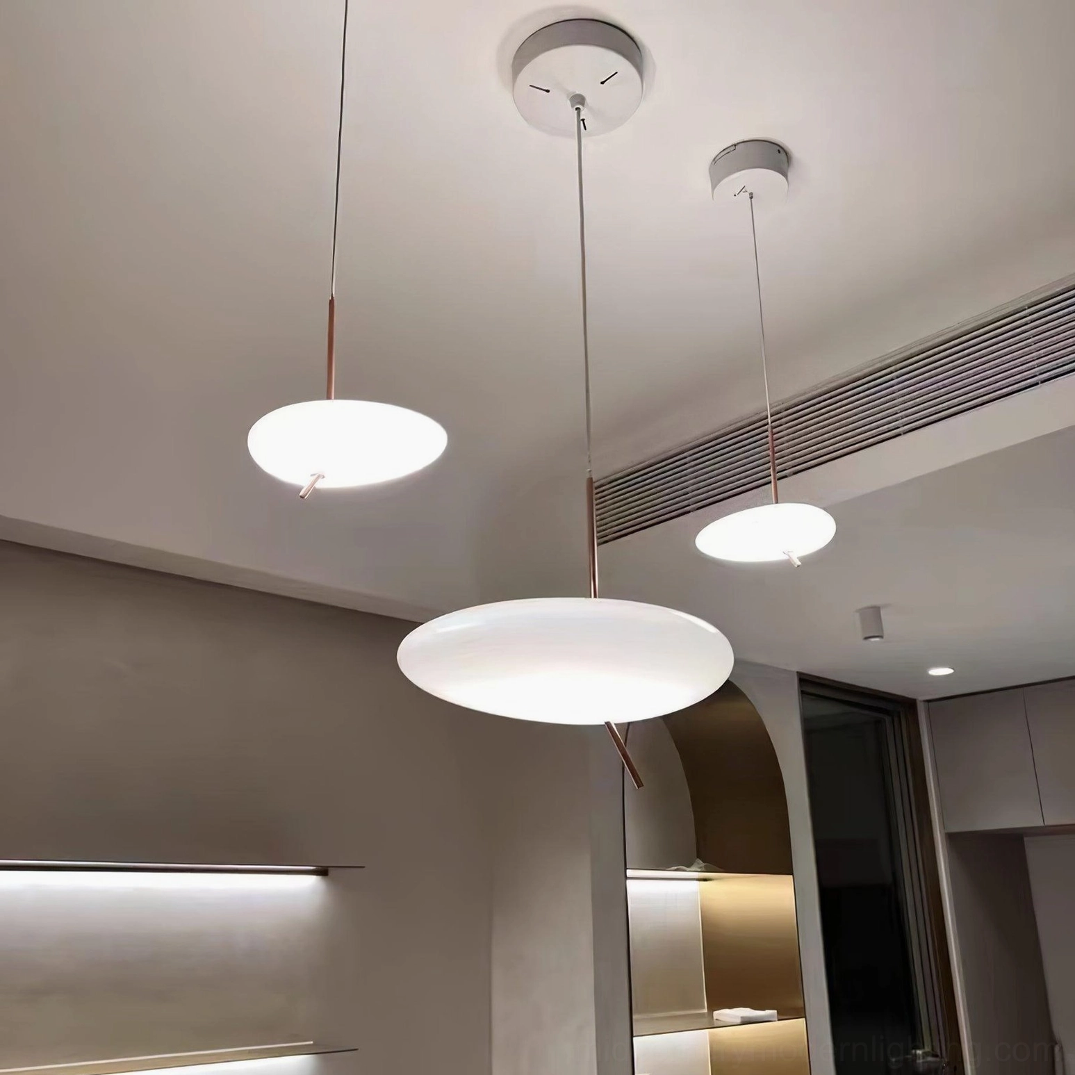 Rose gold pebbles pendant light with white shade in warm contemporary interior design scheme