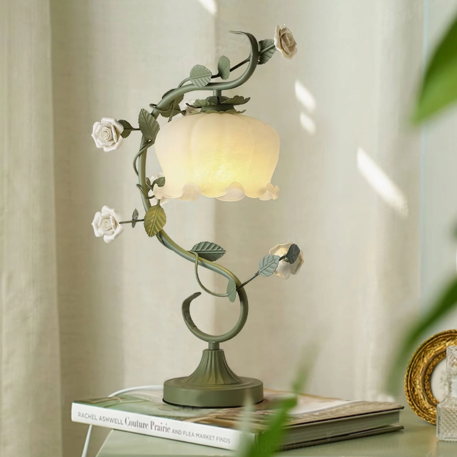 Rose vine table lamp displayed on indoor windowsill with stacked vintage books, French farmhouse style setting