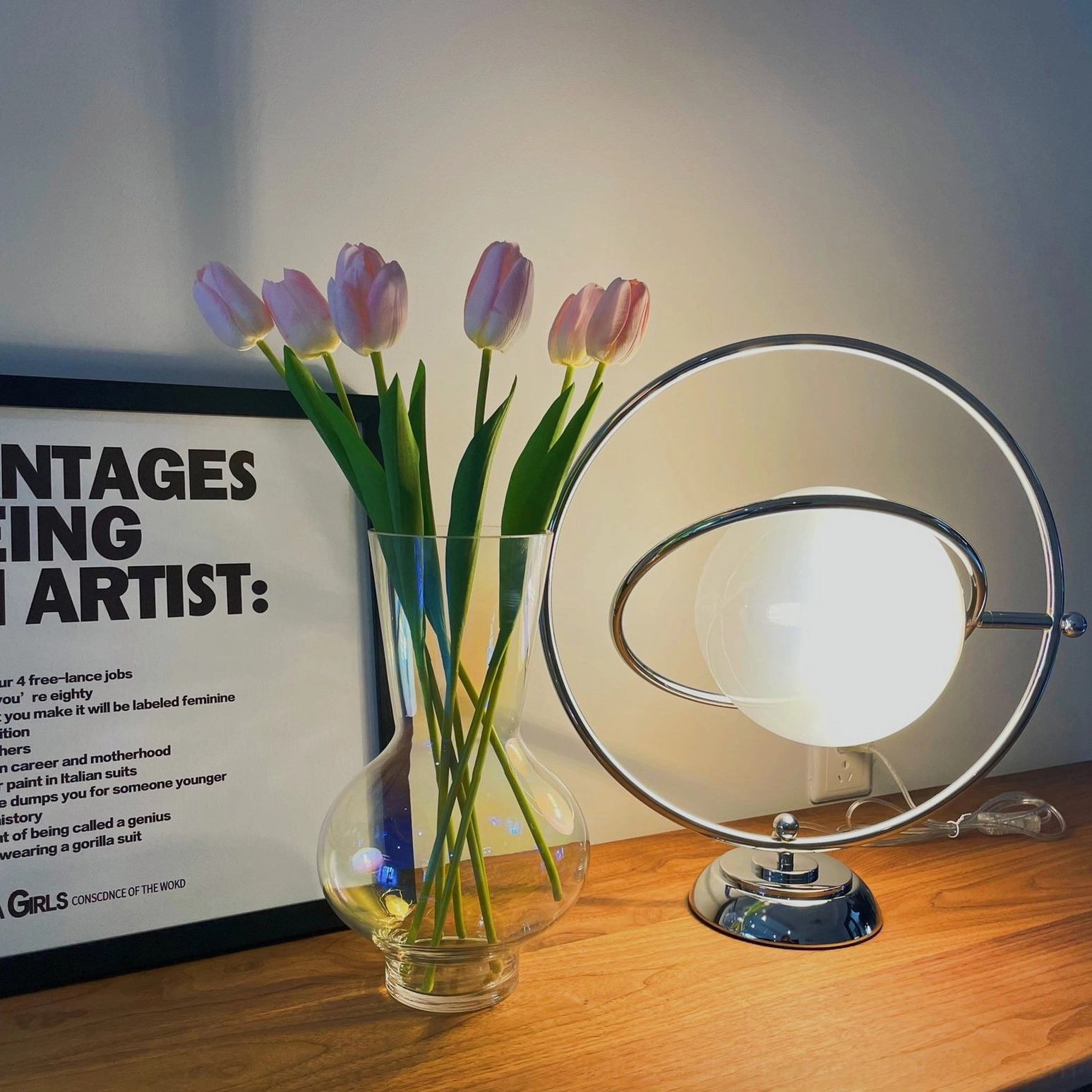 Rotating planet table lamp detail showing 360-degree orbital metal ring mechanism