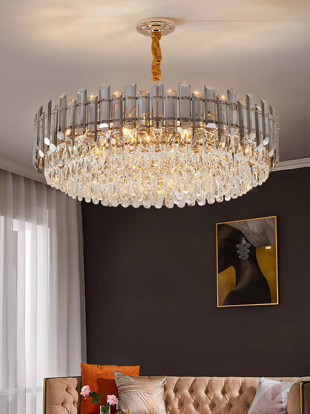 Round tiered crystal chandelier with cascading clear crystal pendants above contemporary seating