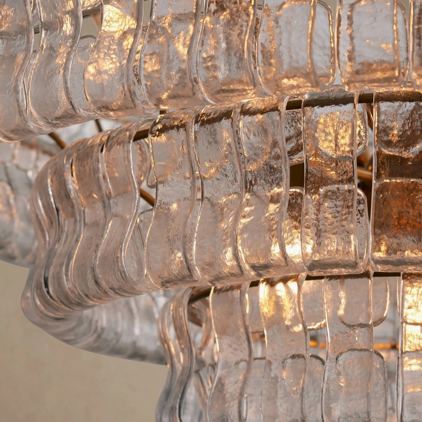 Round tiered chandelier sculptural composition, artisanal ice-textured glass, industrial metal frame architectural form