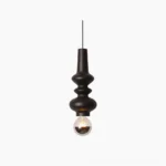 Rudd matte black cylindrical pendant light with stacked cylinder design and exposed bulb, front studio view