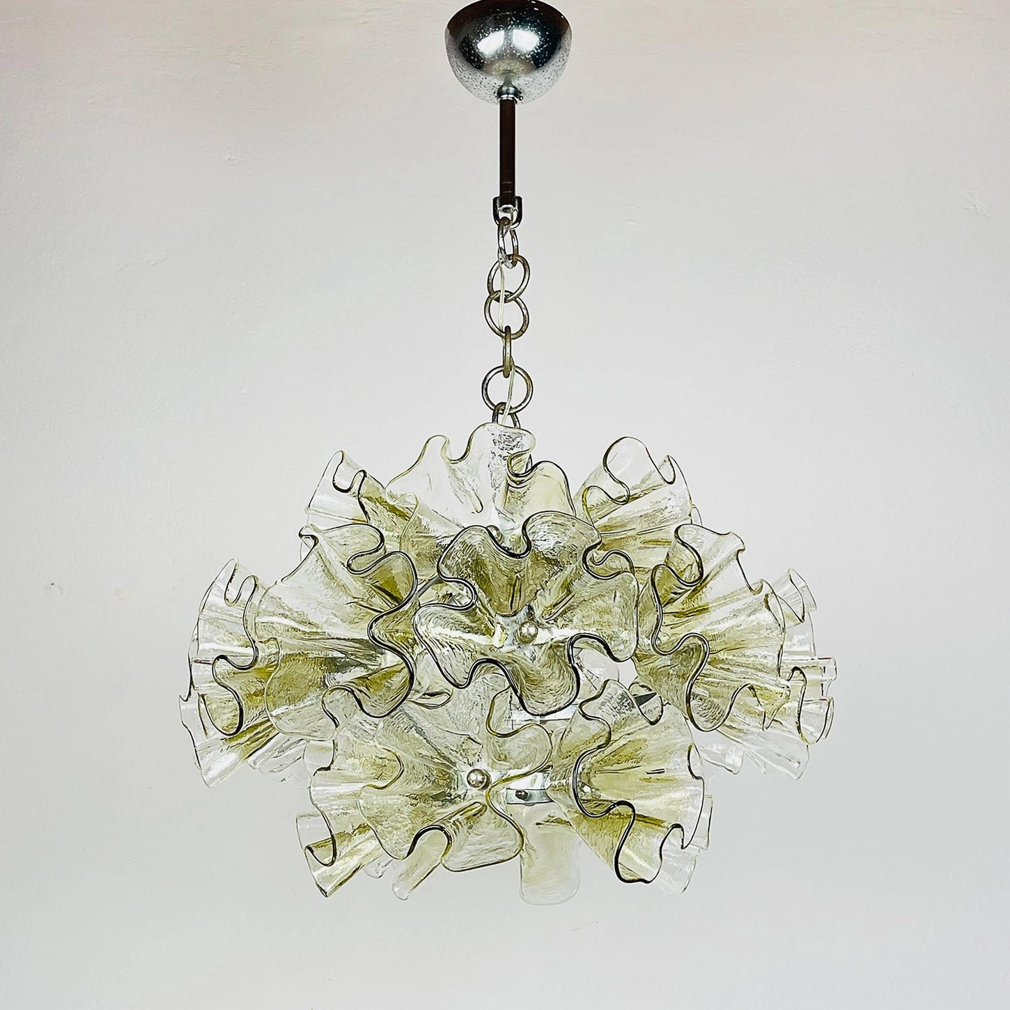 Ruffled glass chandelier with extended chrome hanging rod and full sculptural glass petal structure