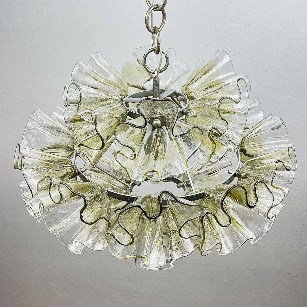 Double-layered ruffled glass petal chandelier with organic wavy edges and chrome metal frame detail