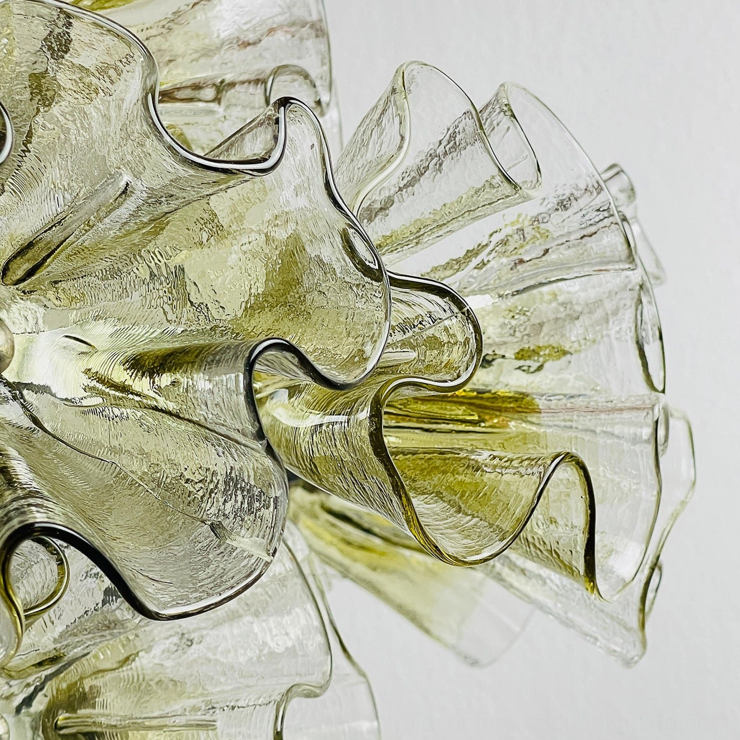Ruffled petal glass sculptural pendant chandelier showing intricate hand-blown petal formation and chrome metal support
