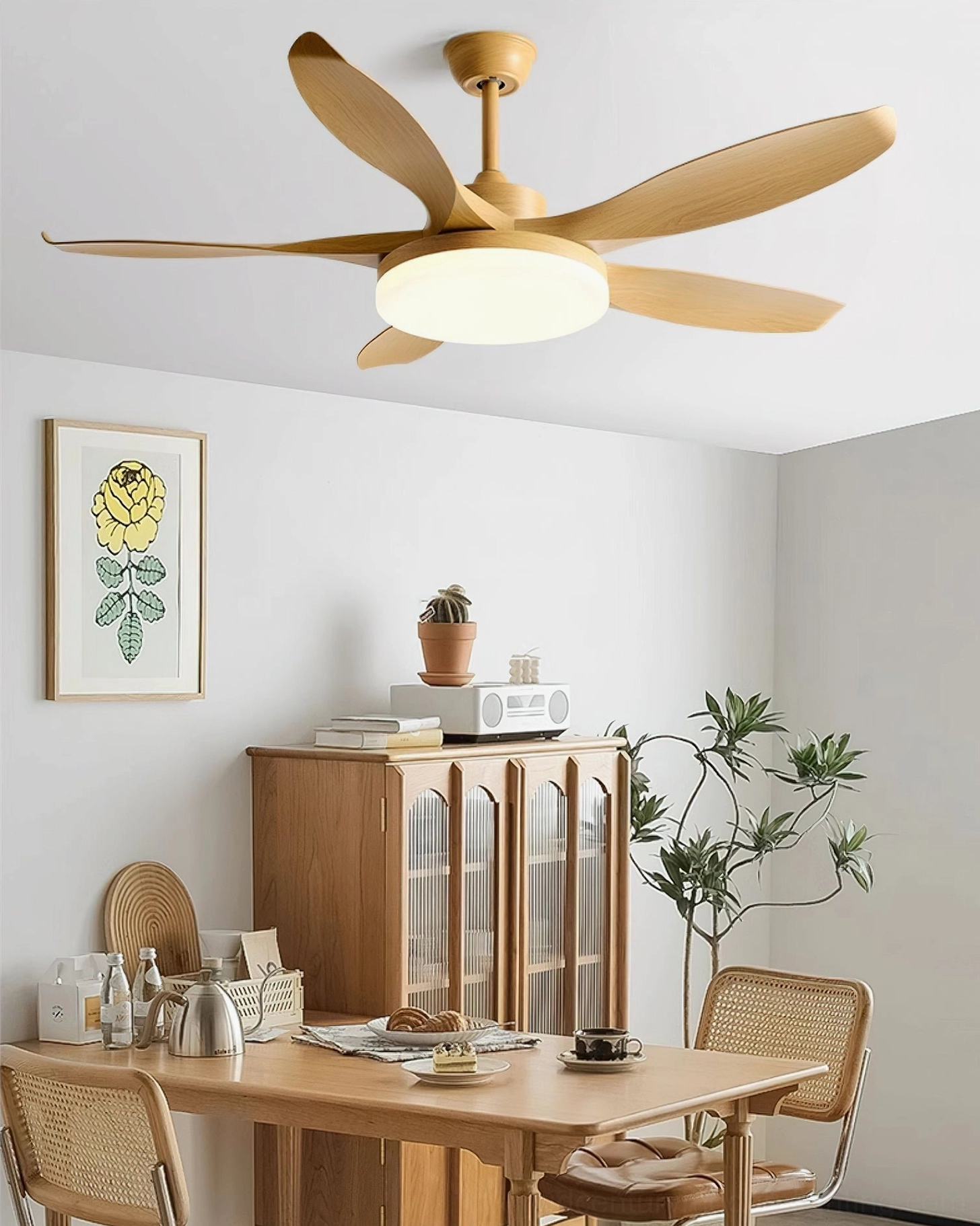 Light golden wood grain ceiling fan light in rustic wooden dining area with wooden cabinet and wall prints