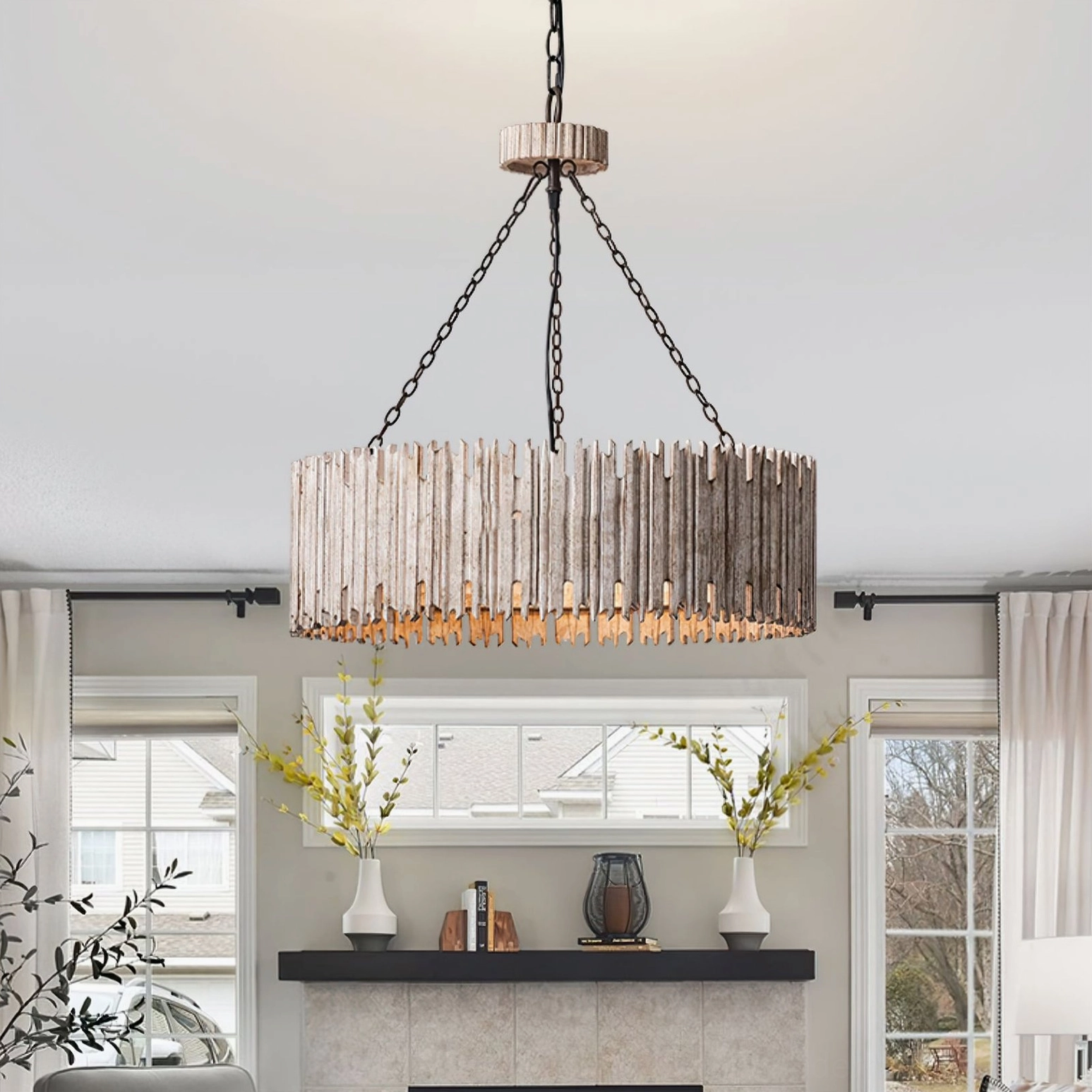 Rustic drum chandelier hanging in farmhouse living room with fireplace, eye-level view of light weathered wood construction