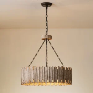 Rustic drum chandelier installed in beige residential room, three-quarter front angle showing weathered wood shade and metal hardware