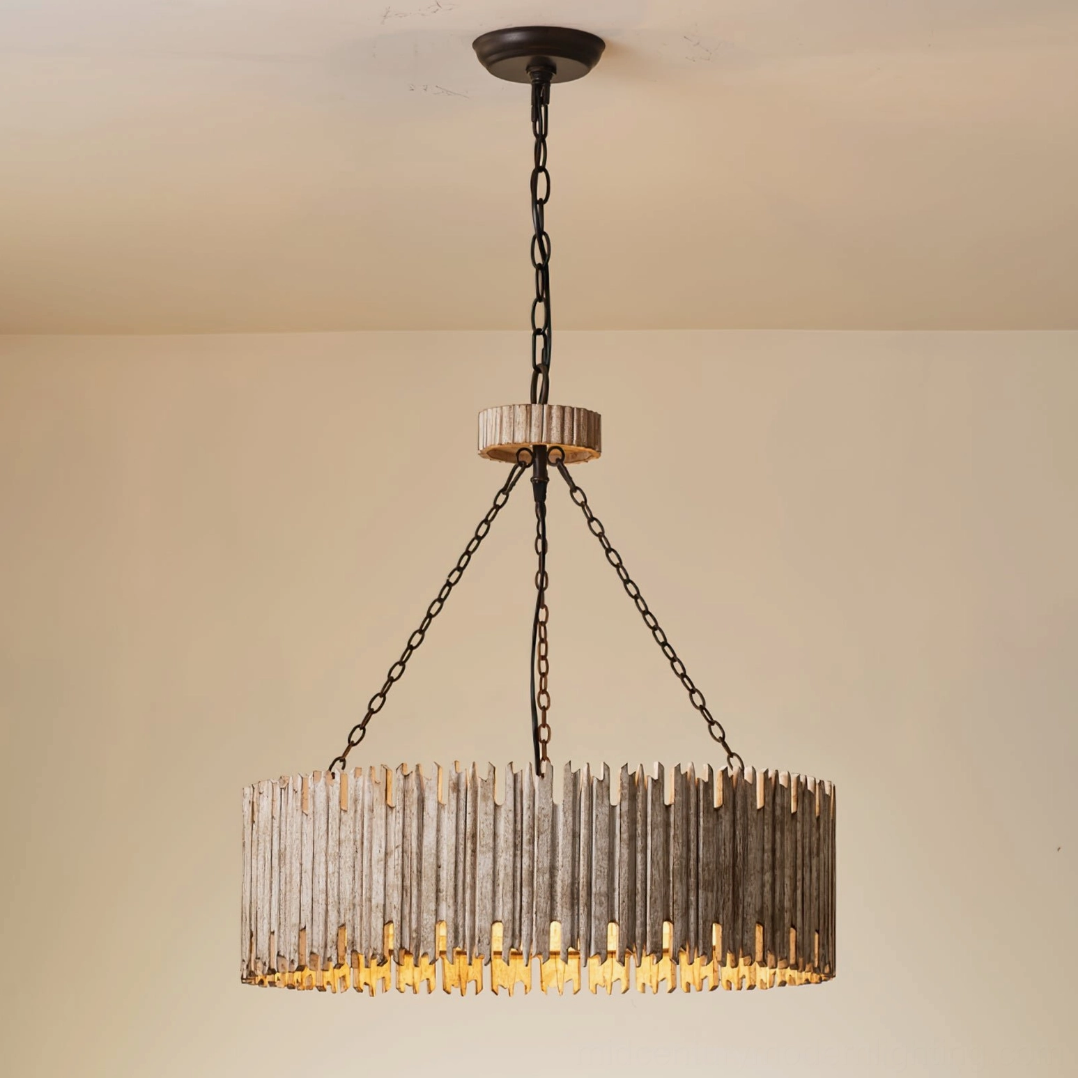 Rustic drum chandelier installed in beige residential room, three-quarter front angle showing weathered wood shade and metal hardware