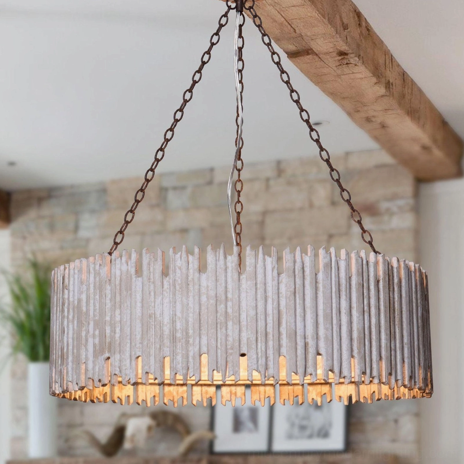 Rustic drum chandelier with stone accent wall background, three-quarter view showing whitewashed wood slats and black suspension chains