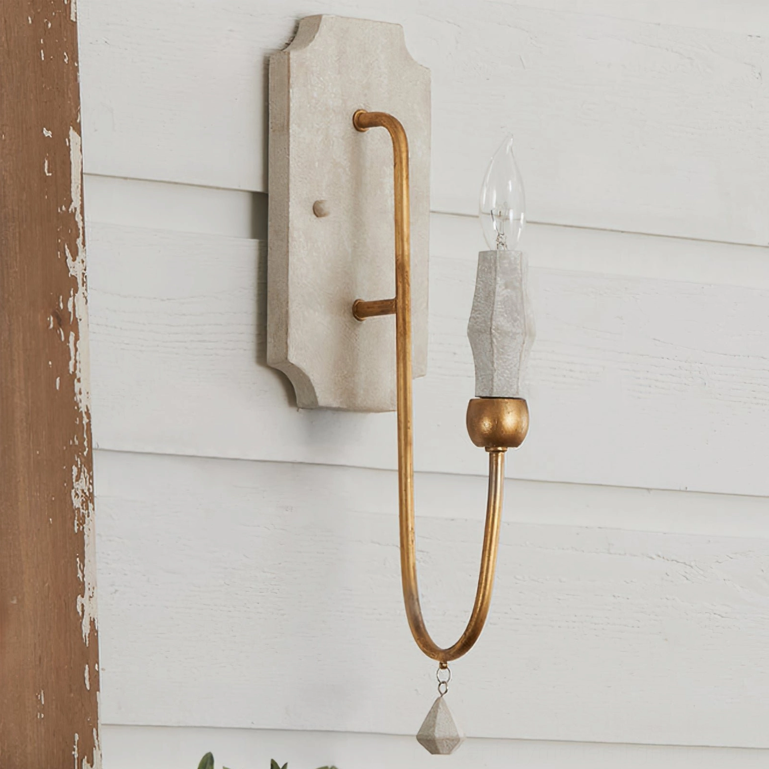 Crystal hanging pendant and bronze candle arm wall sconce with distressed farmhouse wall trim