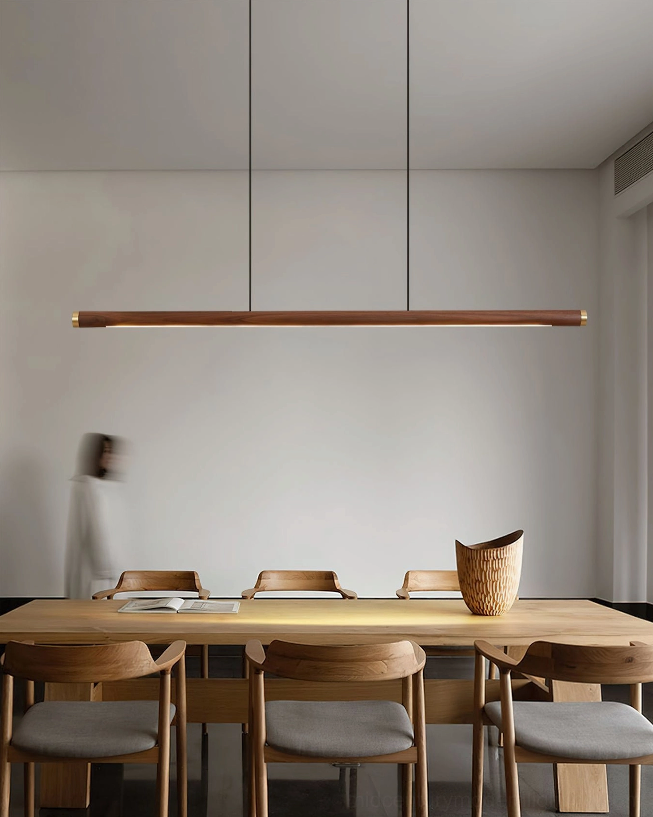 Sabine Linear Wood Chandelier hanging in minimalist dining space with warm natural wood finish
