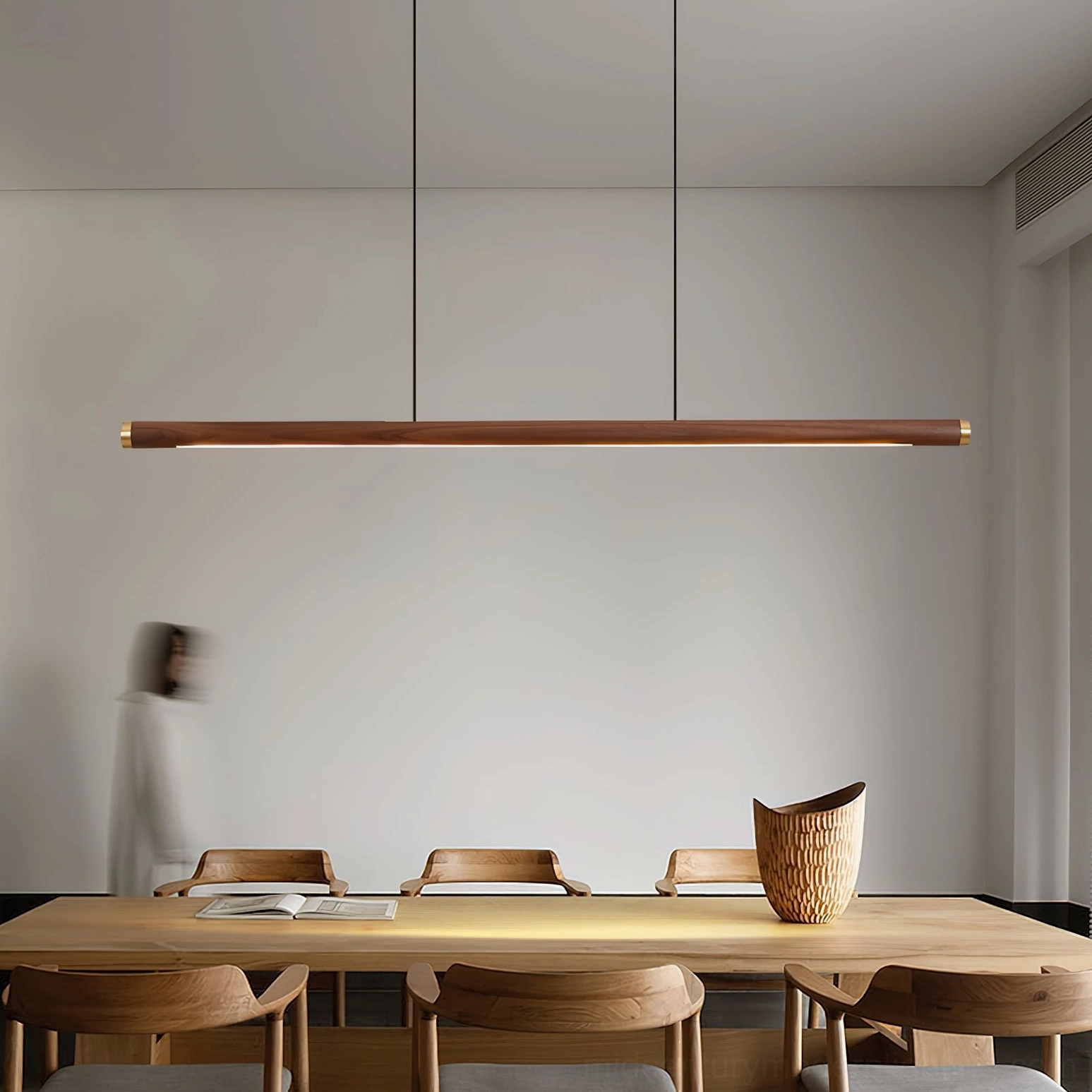 Sabine Linear Chandelier in minimalist dining space with natural wood and warm LED light ambiance