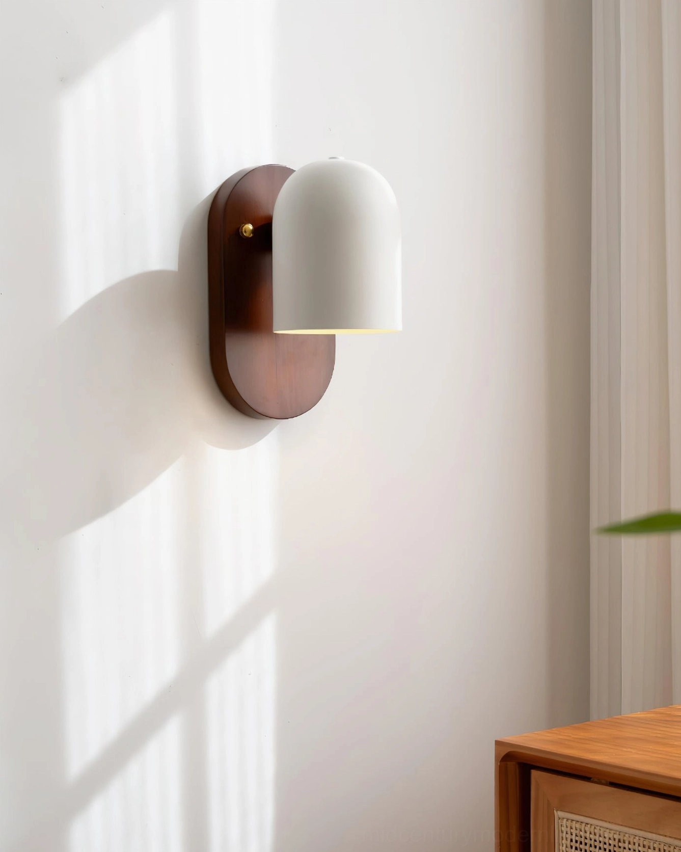 Sable wall sconce in minimalist room with wooden furniture showing sculptural design profile