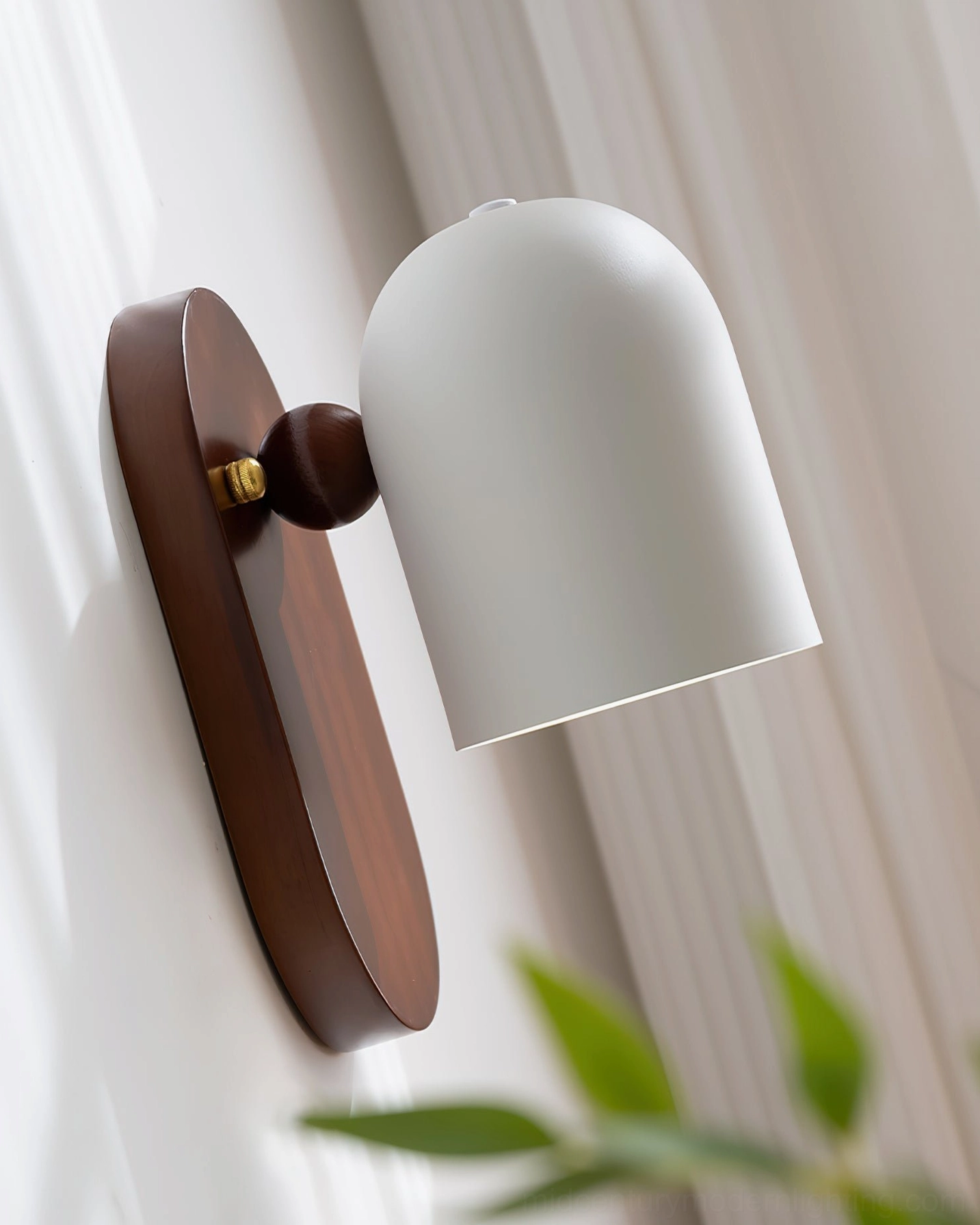 Sable adjustable wall sconce with tilting shade in cozy living area with natural light