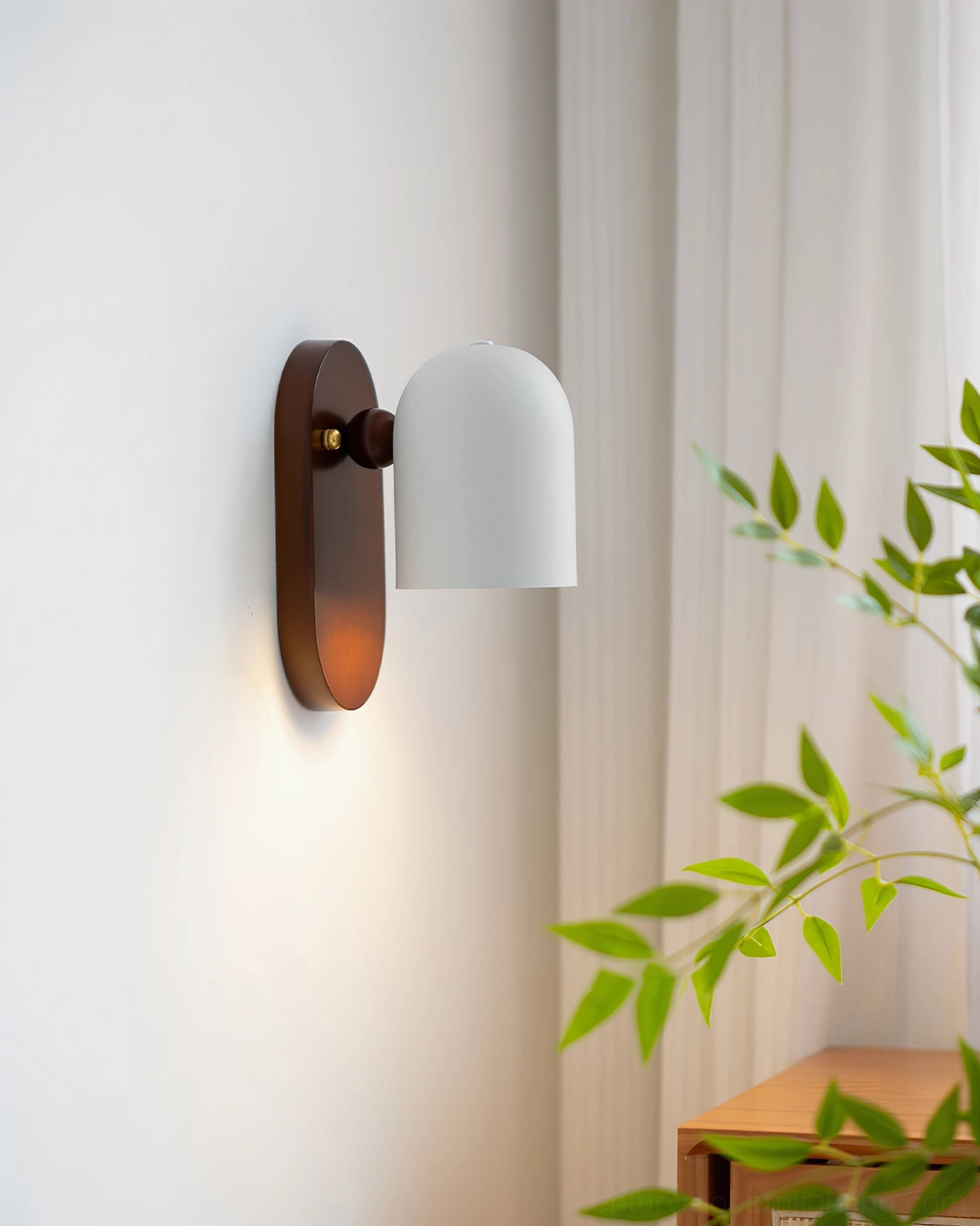 Sable mid-century modern sconce in sunlit bedroom with wooden side table and sheer curtains