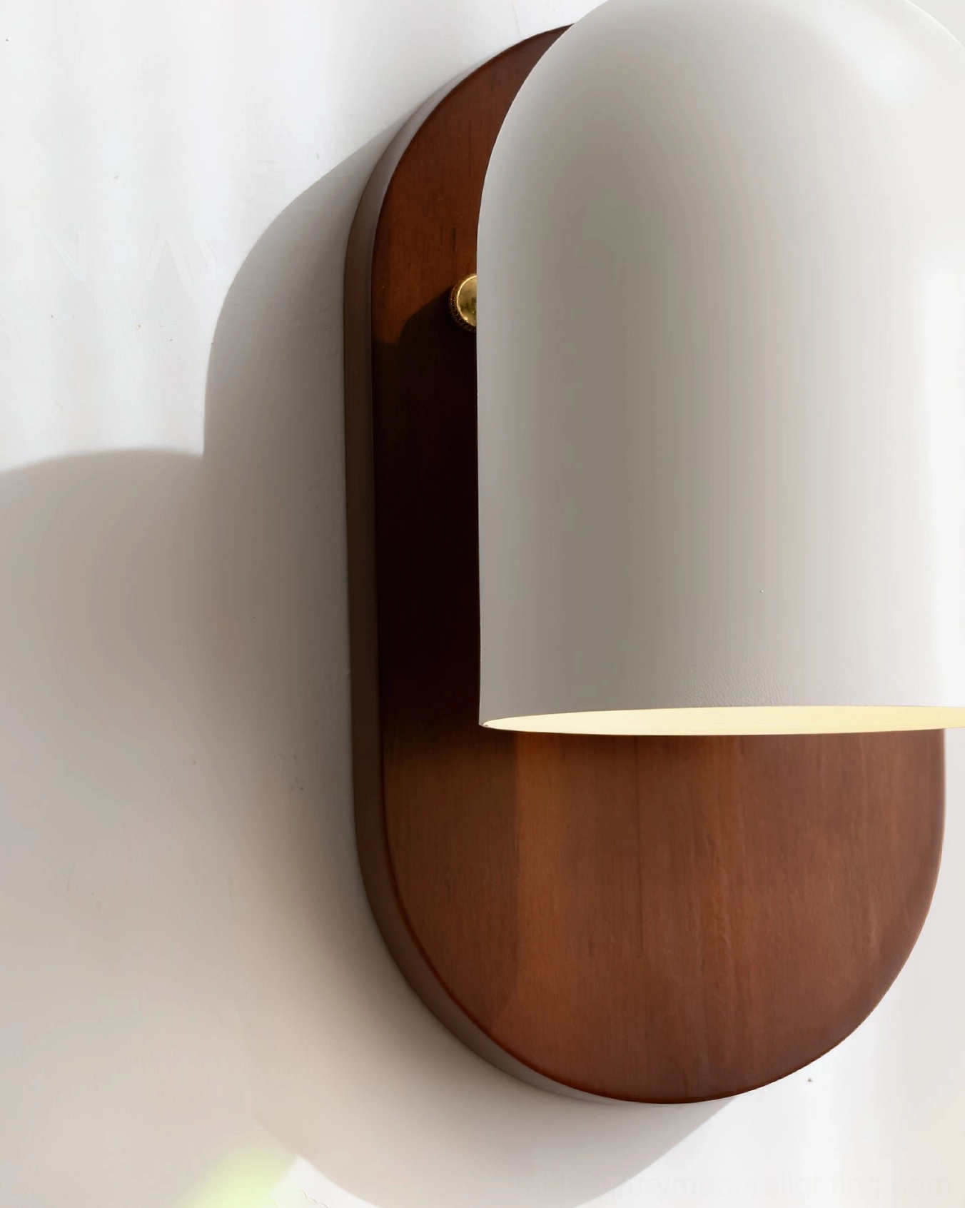 Close-up detail of Sable wall sconce showing brass hardware and white matte shade finish