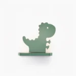 Sage green matte dinosaur wall lamp front view, flat studio shot showing sculptural silhouette and integrated LED backlight design