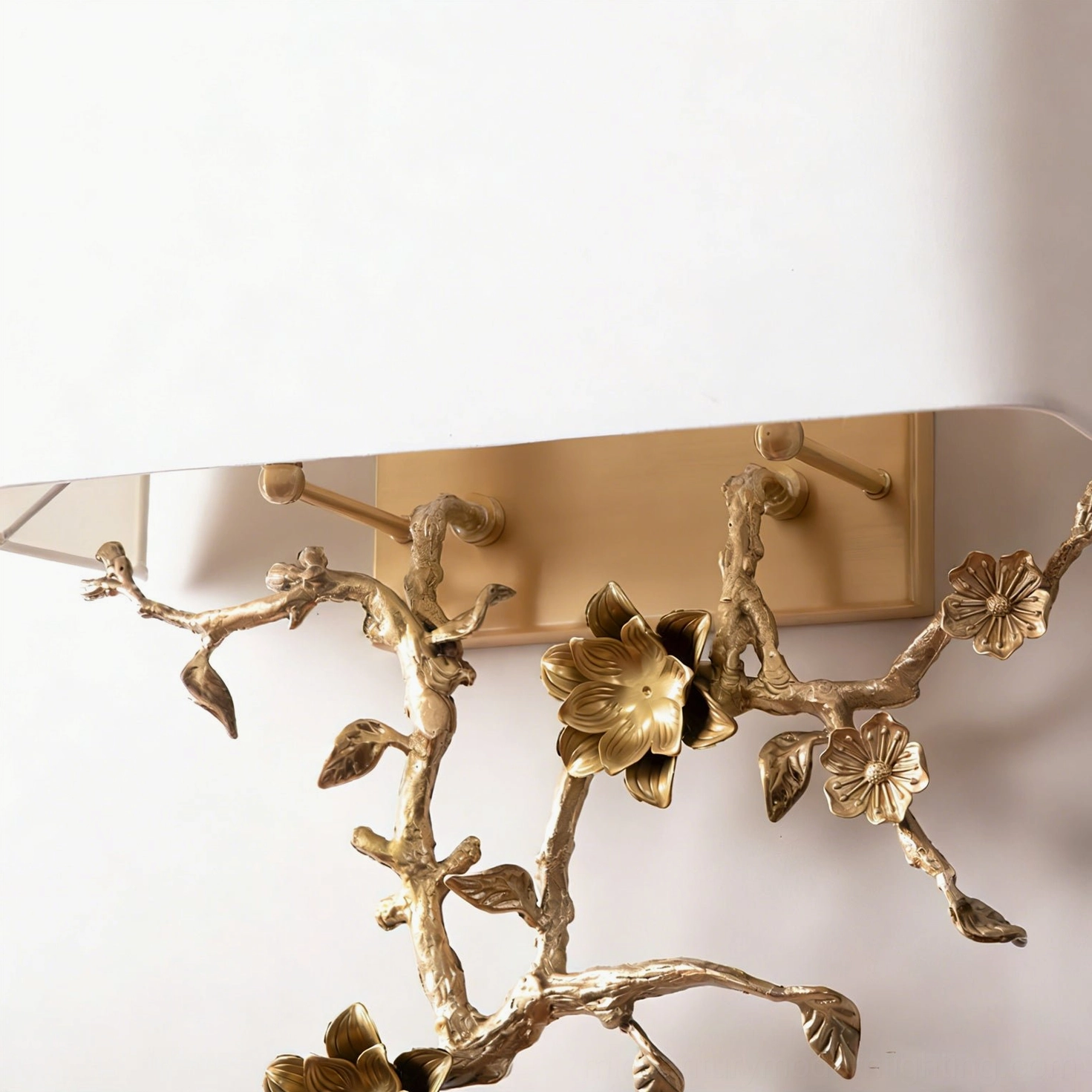 Close-up detail of Sanremo sconce showing intricate hand-crafted brass flower and bird botanical motif with fabric shade edge