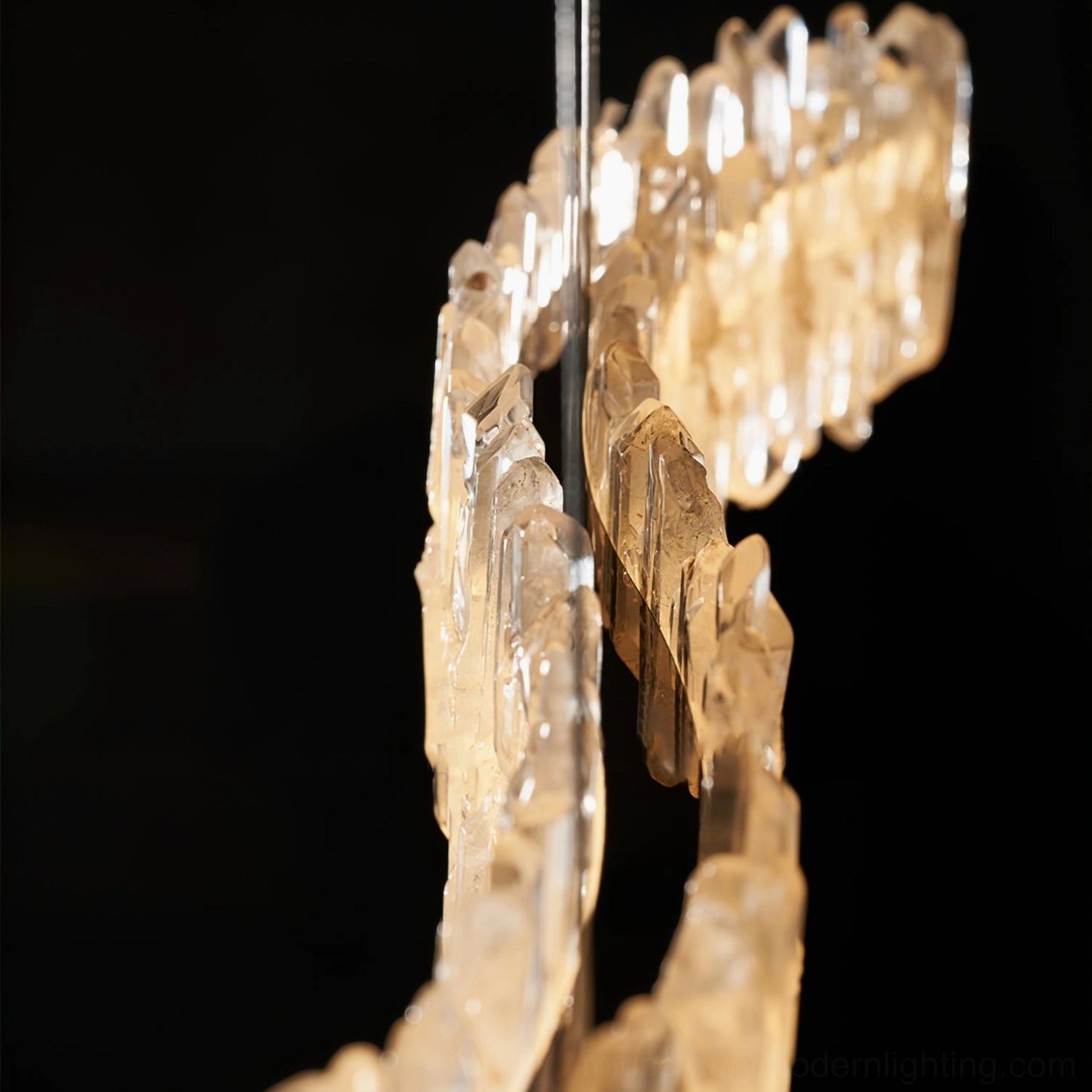 Side view of Sarella chandelier rose gold metal frame and crystal stone structure against neutral background
