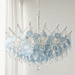 Close-up front view of tiered capiz shell and crystal beads with white metal frame, layered pendant details visible